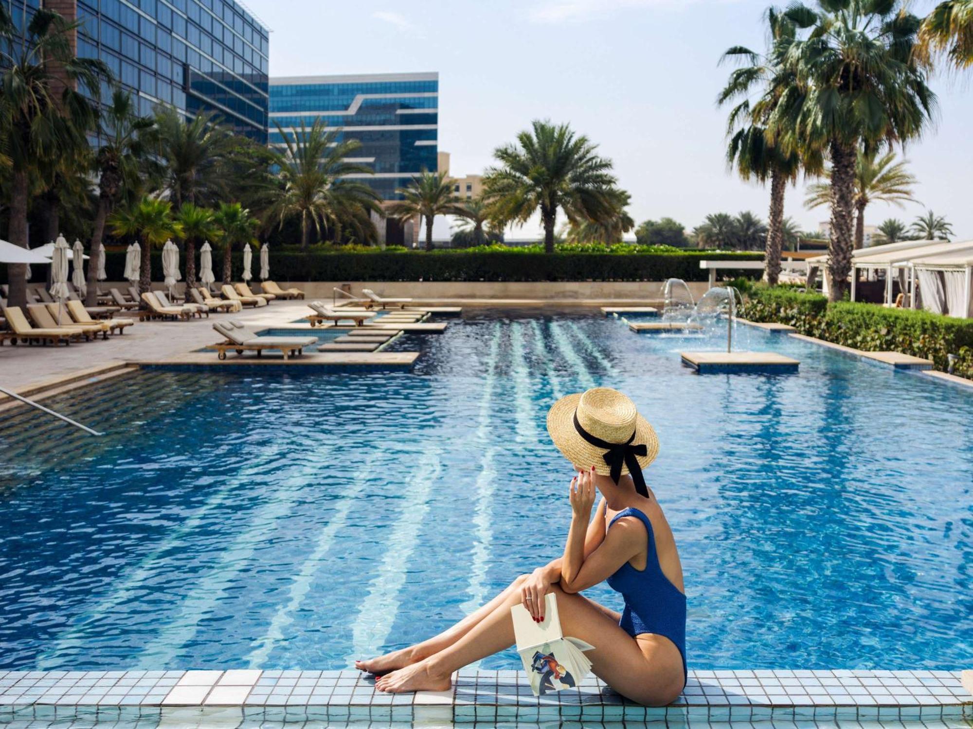 Fairmont Bab Al Bahr Hotel Abu Dhabi Exterior photo A woman sunbathing at a pool
